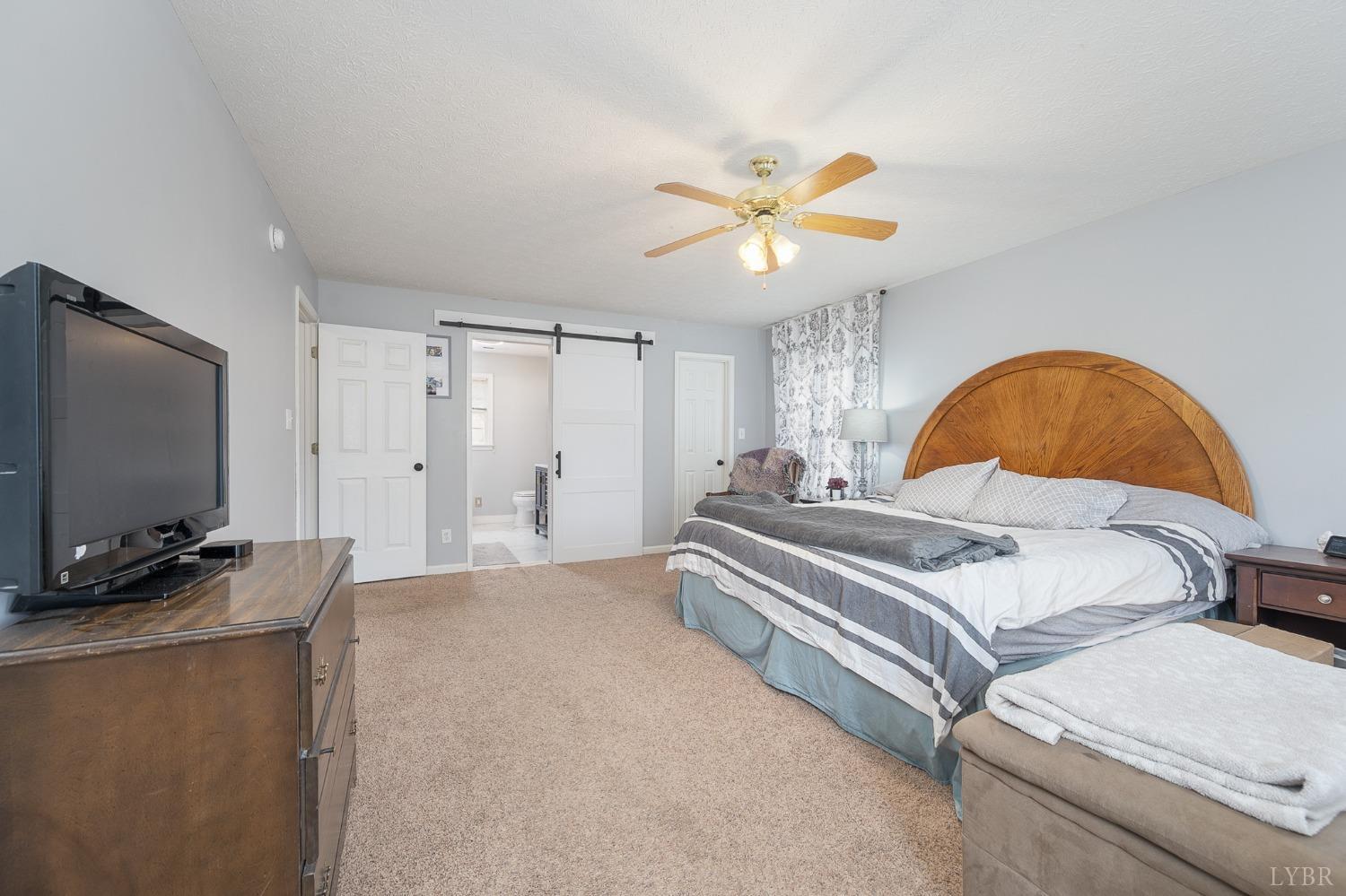 1498 Hooper Road Forest, VA 24551 - Photo 29 of 48 a bedroom with a bed and a flat screen tv