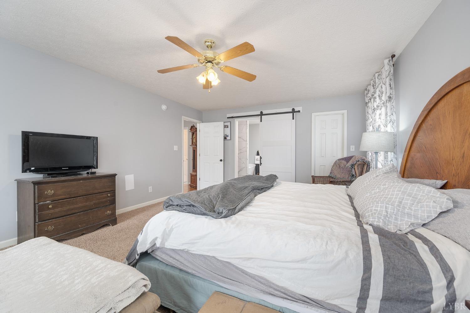 1498 Hooper Road Forest, VA 24551 - Photo 30 of 48 a bedroom with a bed and a flat screen tv