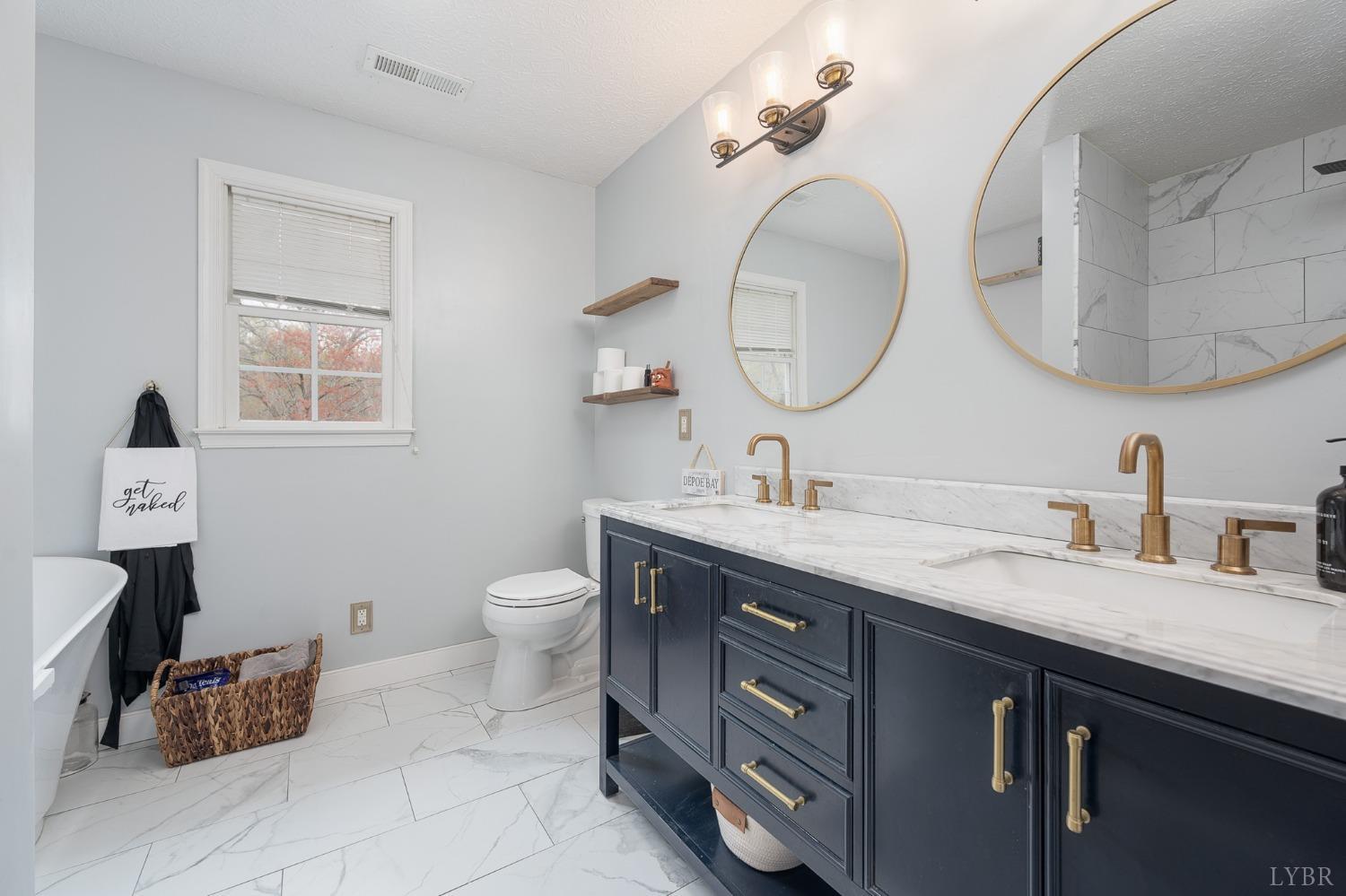 1498 Hooper Road Forest, VA 24551 - Photo 31 of 48 a spacious bathroom with a double vanity sink and a mirror
