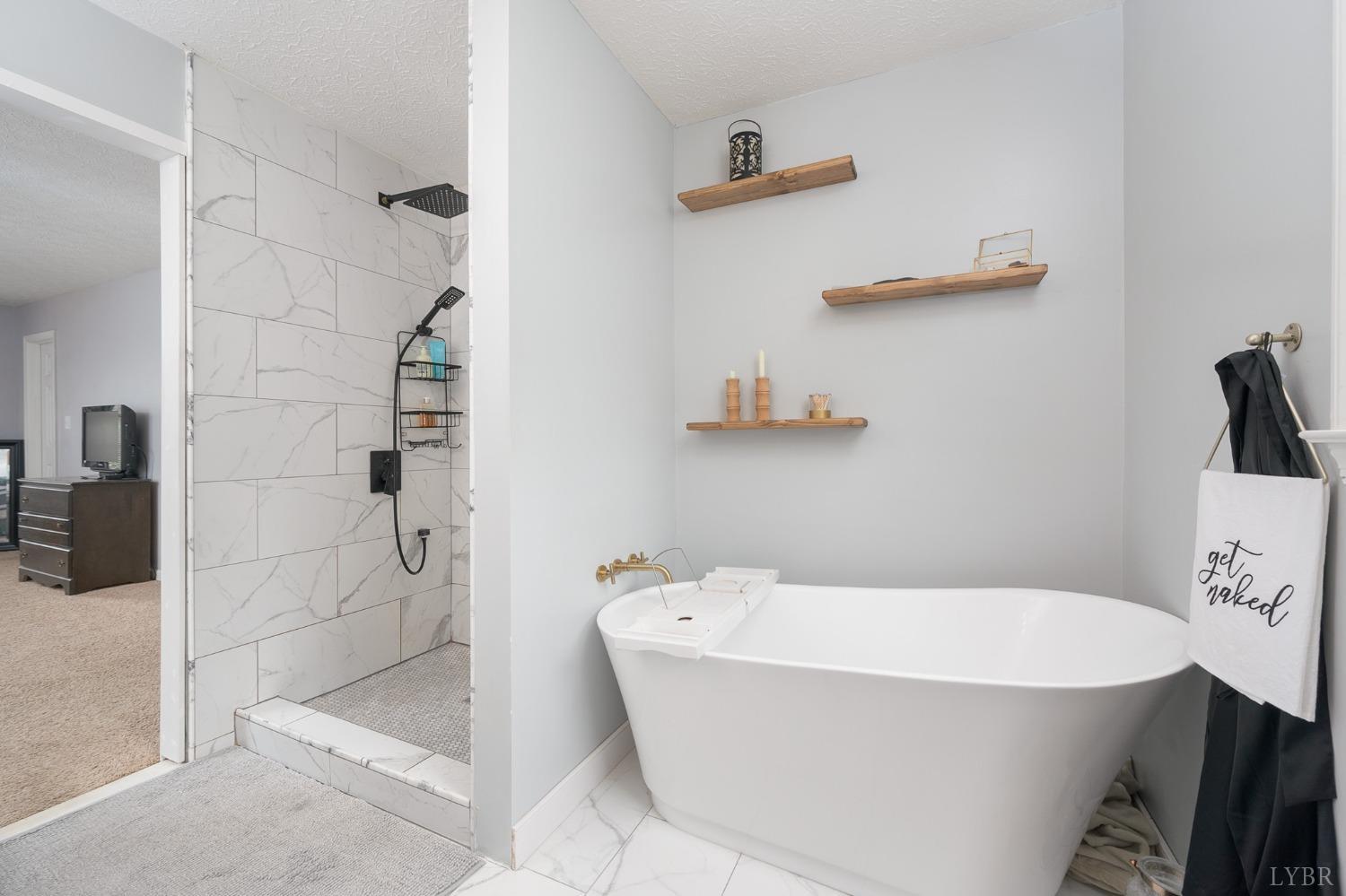 1498 Hooper Road Forest, VA 24551 - Photo 32 of 48 a bathroom with a bathtub and shower