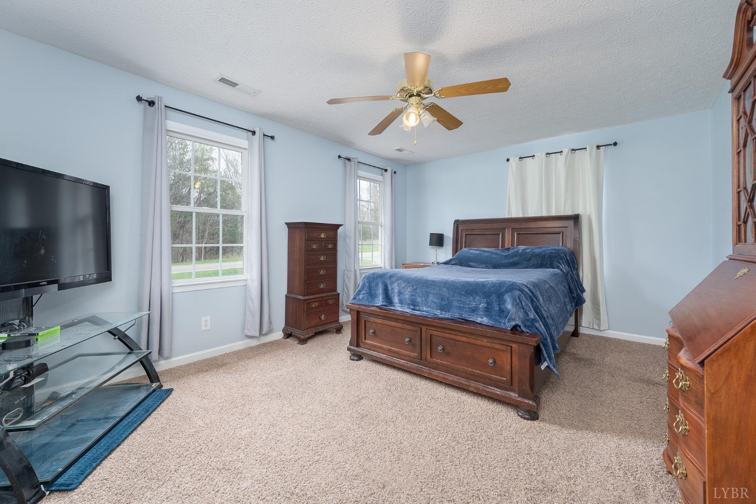 1498 Hooper Road Forest, VA 24551 - Photo 33 of 48 a bedroom with a bed and a flat screen tv