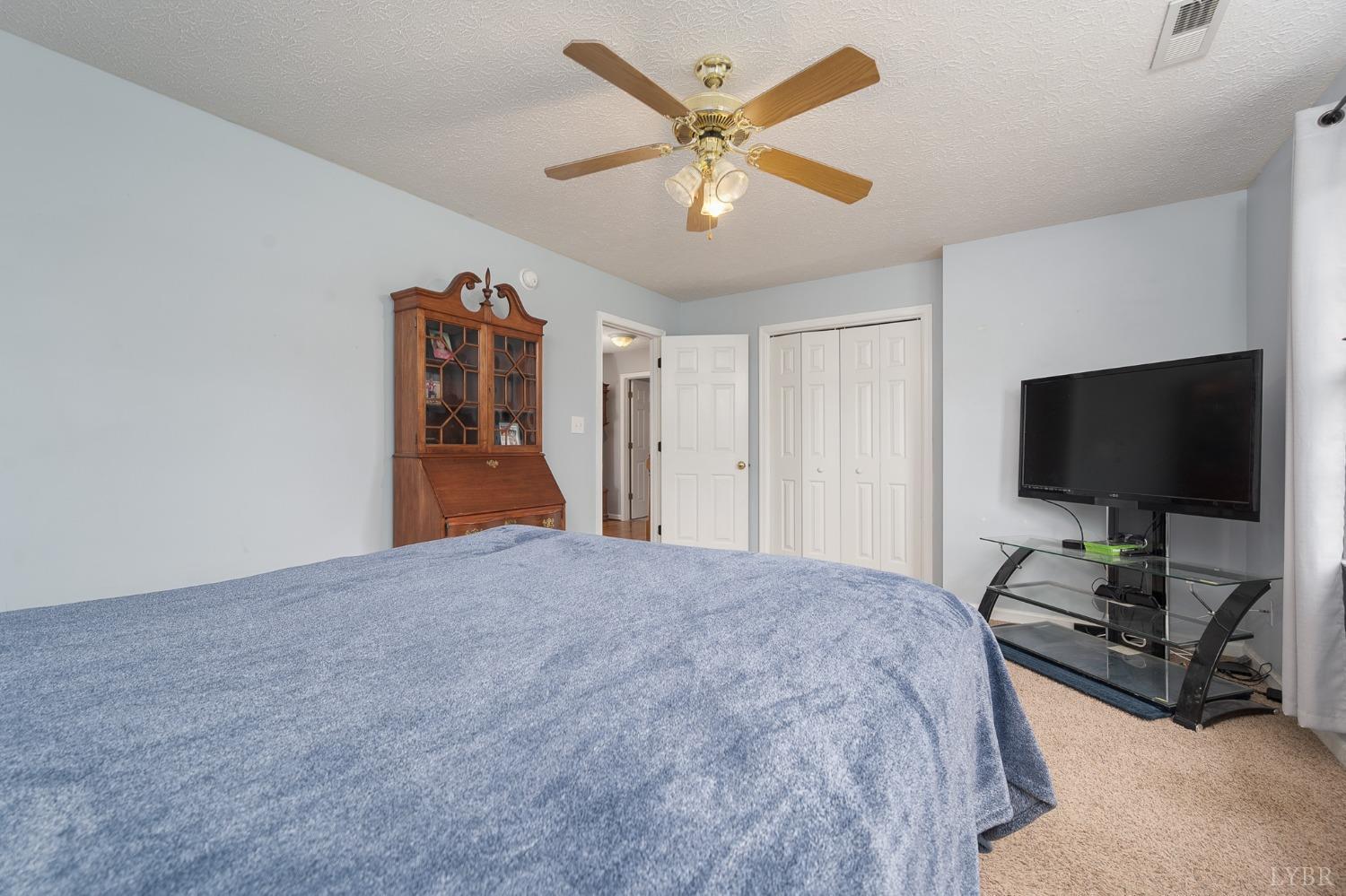 1498 Hooper Road Forest, VA 24551 - Photo 34 of 48 a bedroom with bed and a flat tv screen on dresser