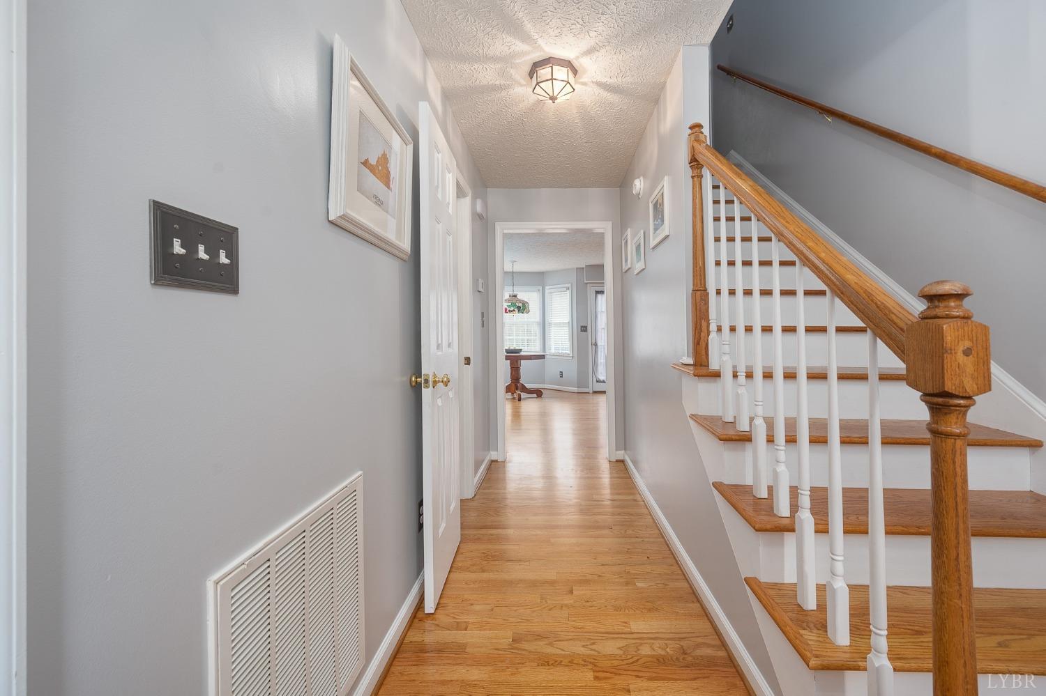1498 Hooper Road Forest, VA 24551 - Photo 9 of 48 a view of a hallway with wooden floor and staircase