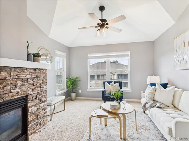 a living room with furniture and a fireplace