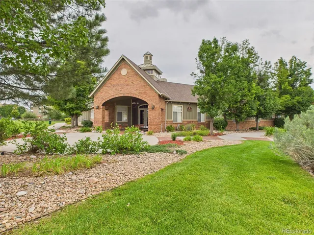 a front view of a house with yard and green space