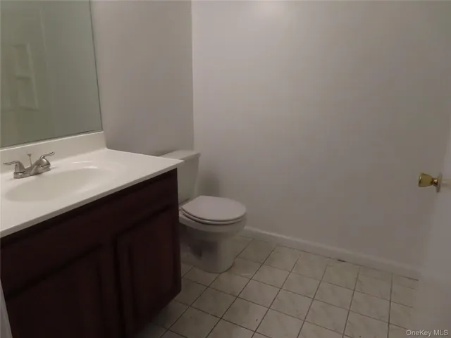 a bathroom with a sink a toilet and a vanity