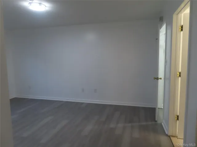 an empty room with wooden floor