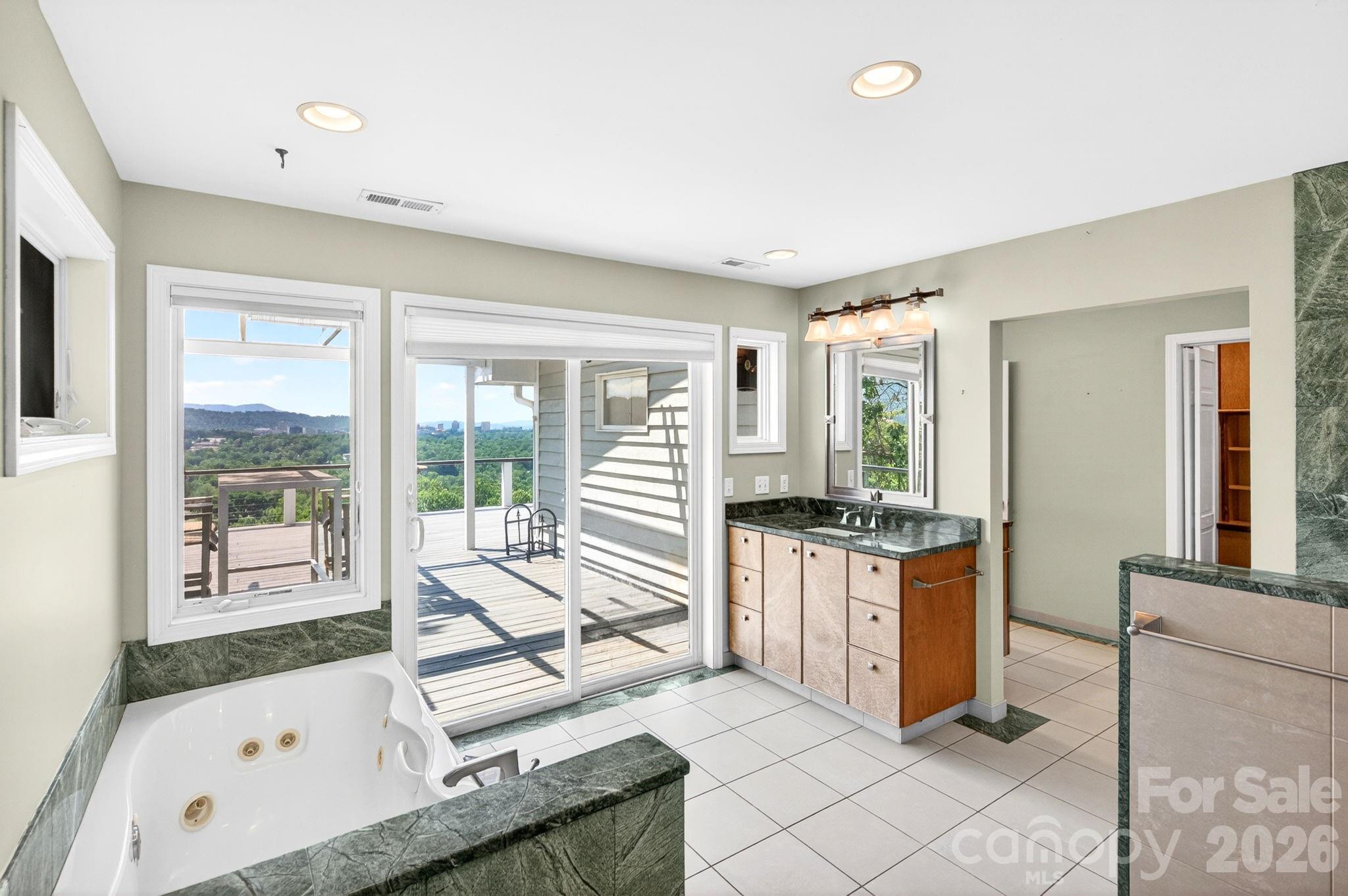 38 Lookout Road Asheville, NC 28804 - Photo 21 of 34 a room with kitchen island granite countertop a large window and a counter space
