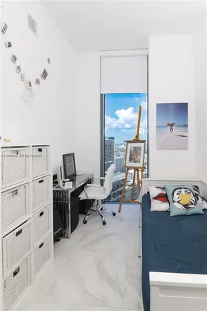 a bedroom with furniture and a window