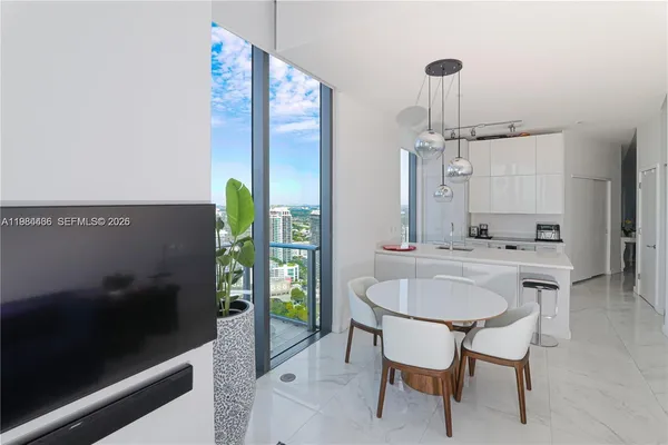 a dining room with furniture and window