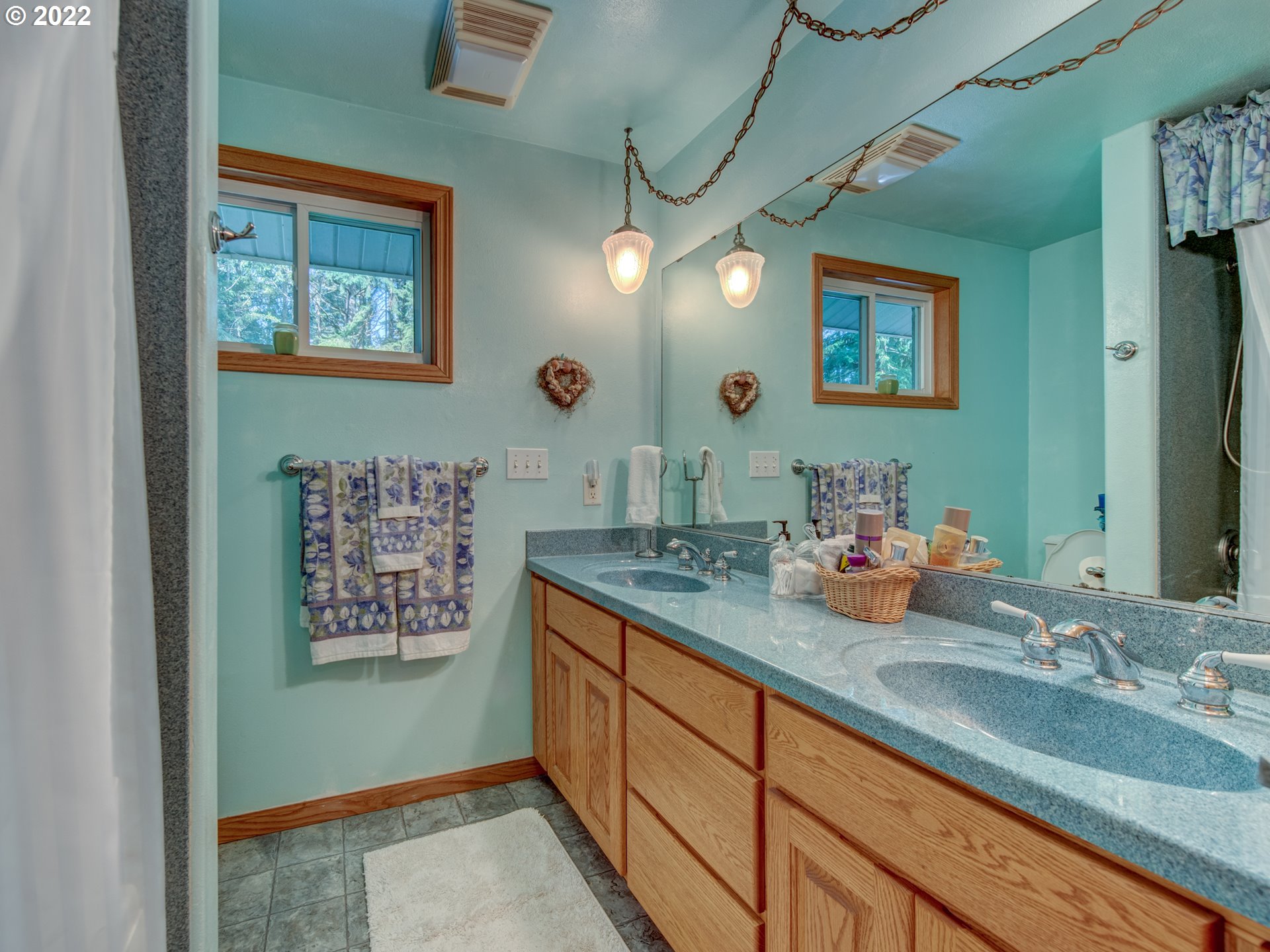 87125 Cedar Flat Road Springfield, OR 97478 - Photo 13 of 32 a bathroom with a sink a mirror and a picture on the wall