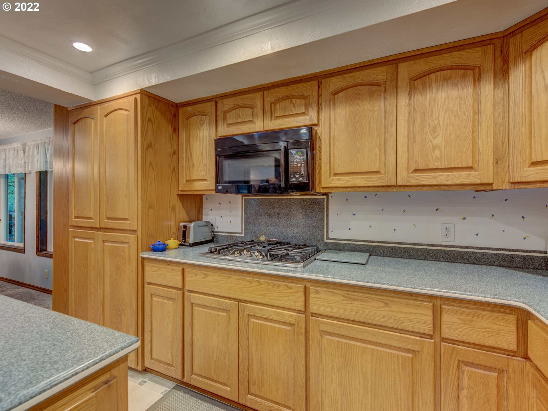 87125 Cedar Flat Road Springfield, OR 97478 - Photo 5 of 32 a kitchen with stainless steel appliances granite countertop a refrigerator a stove a sink and dishwasher with wooden cabinets