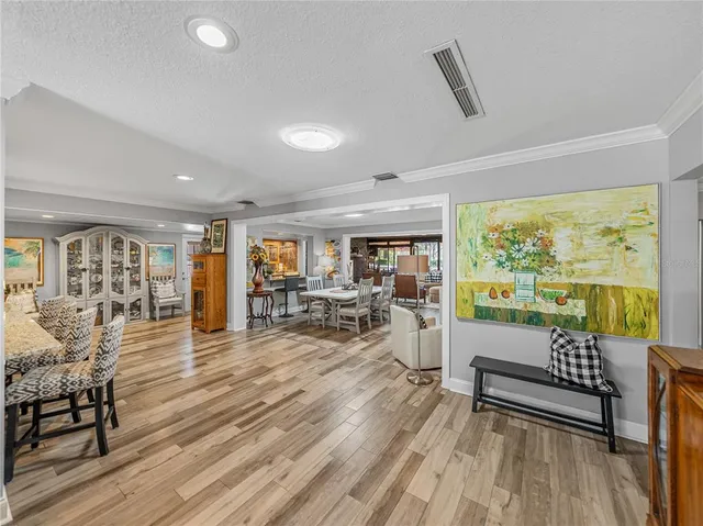 a living room with furniture a fireplace and a chandelier