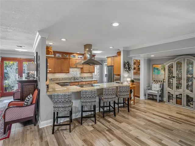 a bedroom with a bed a large window with table and chairs