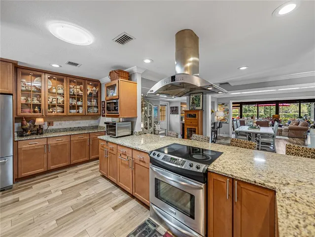 a living room with furniture a ceiling fan and a window