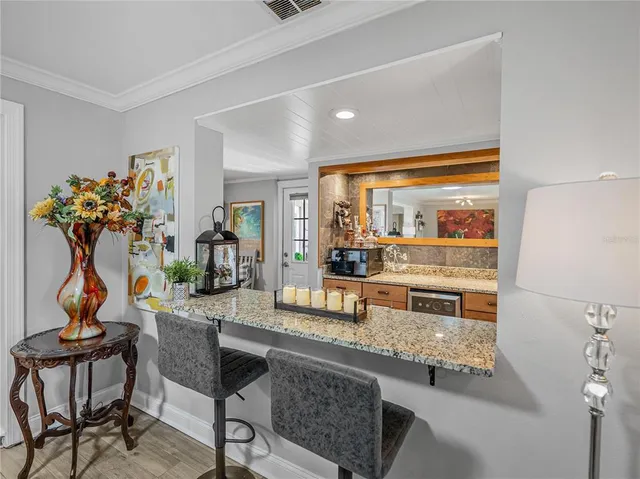 a view of a patio with a dining table and chairs under an umbrella