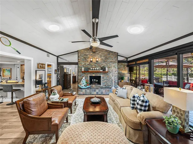 an aerial view of green landscape with trees houses and lake view