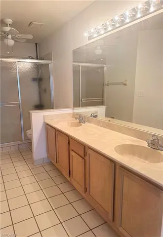 a spacious bathroom with a sink a mirror and a shower