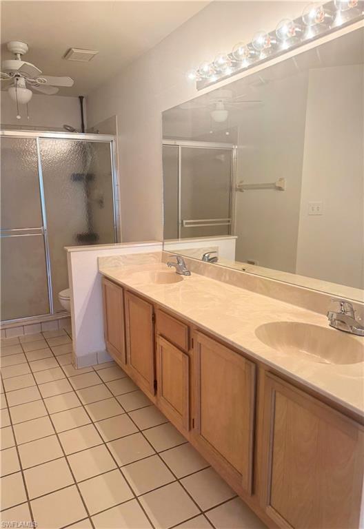 9852 Luna Circle, Unit B203 Naples, FL 34109 - Photo 12 of 16 a spacious bathroom with a sink a mirror and a shower