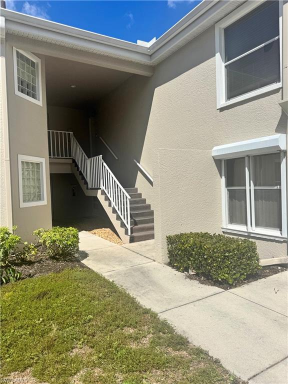 9852 Luna Circle, Unit B203 Naples, FL 34109 - Photo 16 of 16 a view of a house with a yard