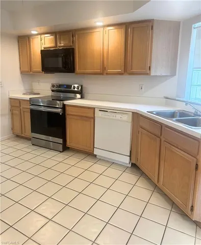 a kitchen with a sink and a stove top oven