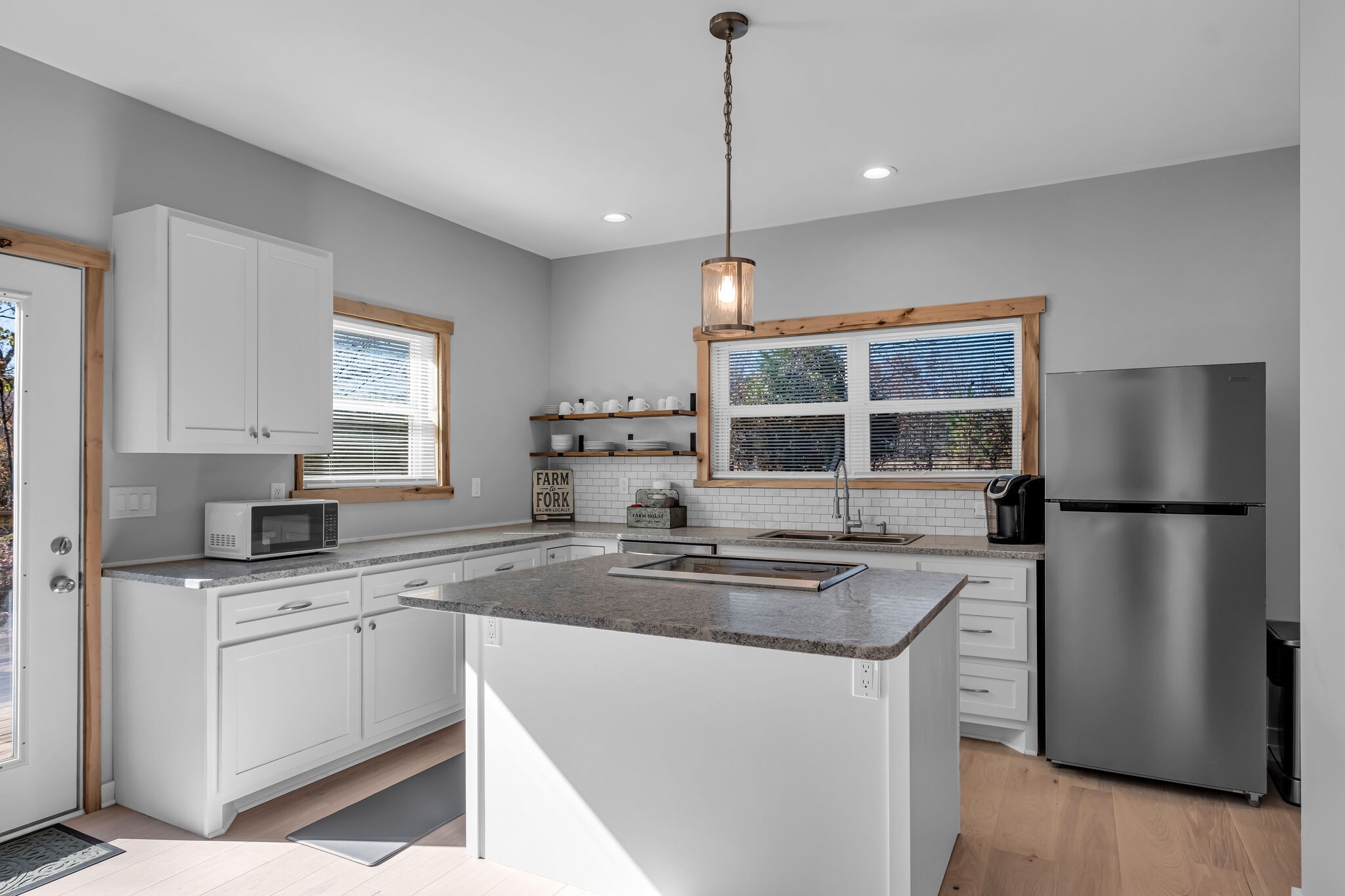 761 Metal Ford Road Hohenwald, TN 38462 - Photo 35 of 60 a kitchen with stainless steel appliances granite countertop a refrigerator a sink a stove and white cabinets