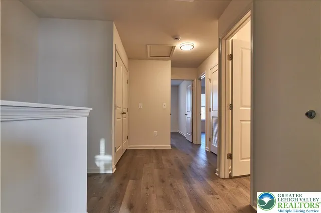 a view of hallway with wooden floor