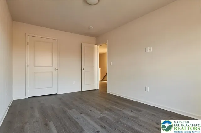 a view of an empty room and wooden floor