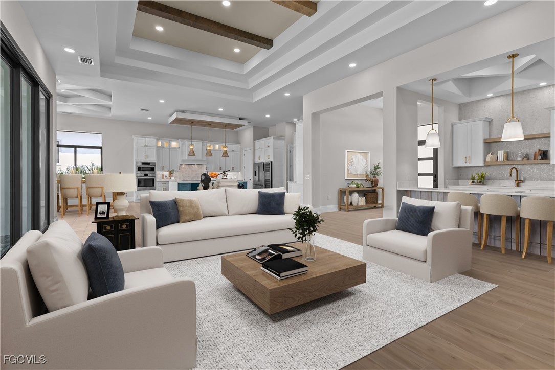 a living room with furniture and view of kitchen