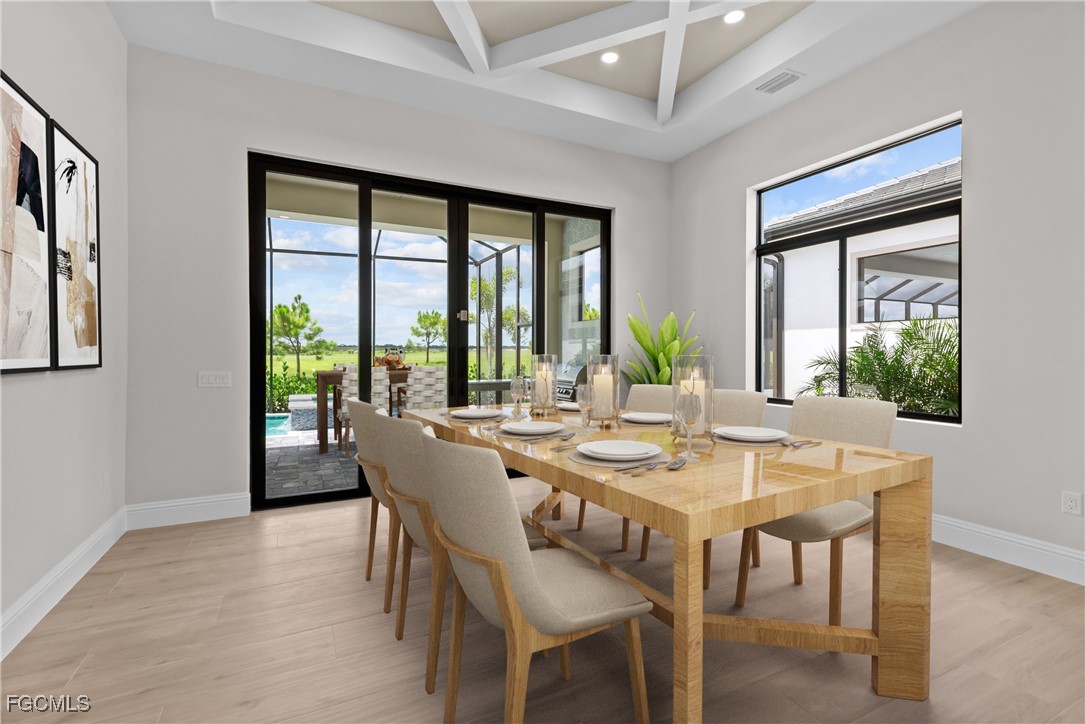 3383 Chestnut Grove Drive Alva, FL 33920 - Photo 11 of 33 a view of a dining room with furniture large windows and wooden floor