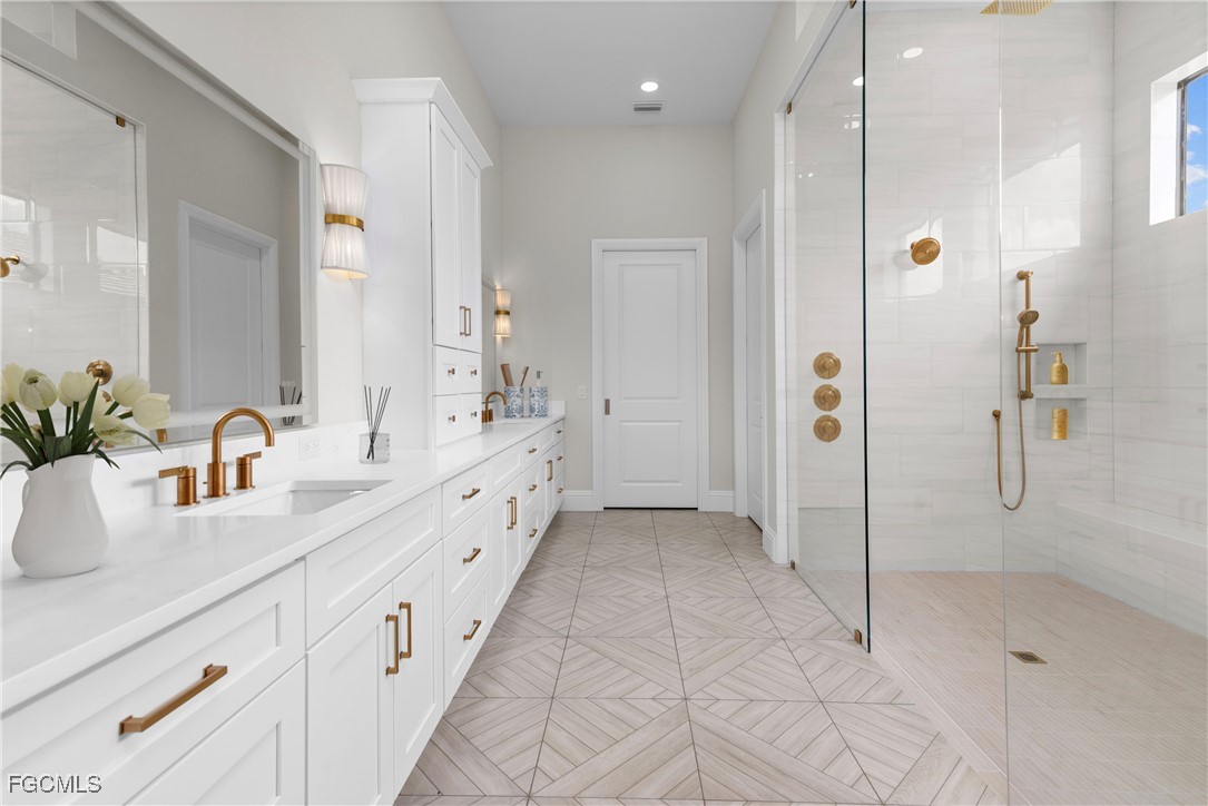 3383 Chestnut Grove Drive Alva, FL 33920 - Photo 14 of 33 a bathroom with a double sink shower and a mirror