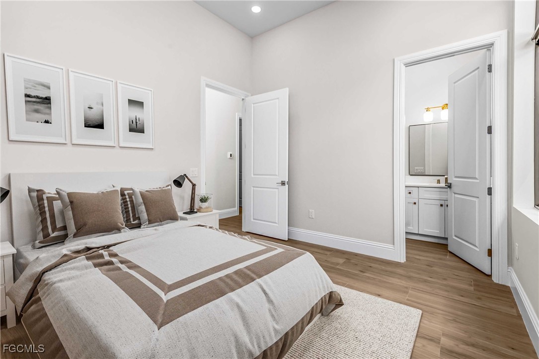 3383 Chestnut Grove Drive Alva, FL 33920 - Photo 16 of 33 a spacious bedroom with a bed and a view of bathroom