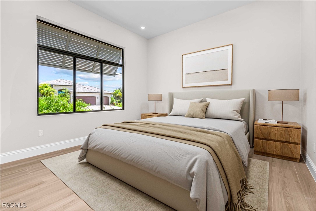 3383 Chestnut Grove Drive Alva, FL 33920 - Photo 18 of 33 a bedroom with a bed and a painting on the wall