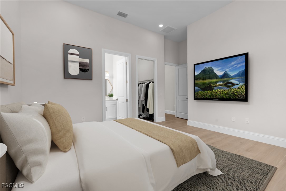 3383 Chestnut Grove Drive Alva, FL 33920 - Photo 19 of 33 a bedroom with a bed and a painting on the wall