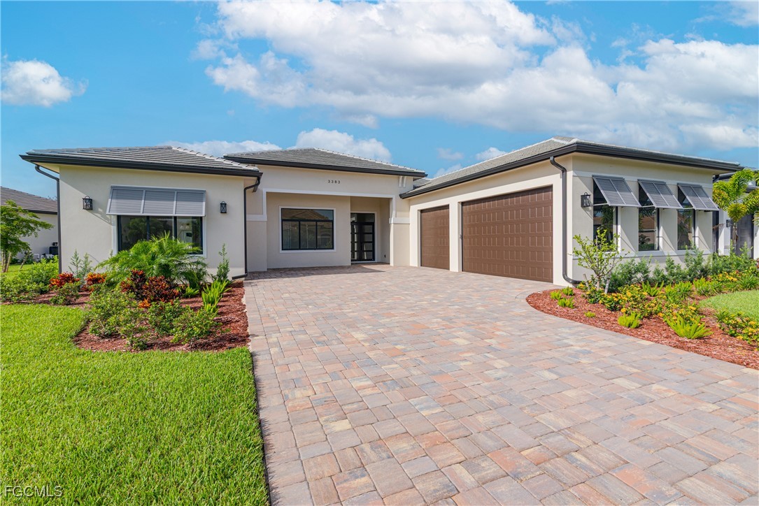 3383 Chestnut Grove Drive Alva, FL 33920 - Photo 2 of 33 a front view of house with yard and trees around