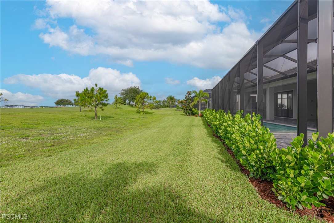 3383 Chestnut Grove Drive Alva, FL 33920 - Photo 31 of 33 a view of a garden with a building in the background