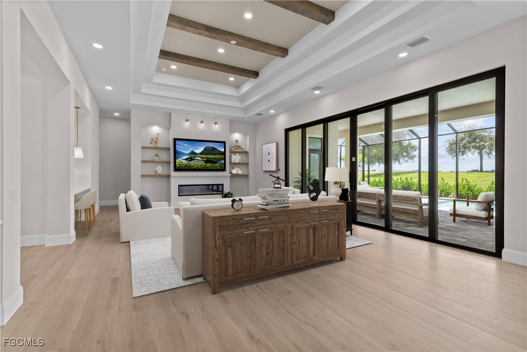 3383 Chestnut Grove Drive Alva, FL 33920 - Photo 4 of 33 a large living room with stainless steel appliances granite countertop a couch and a flat screen tv