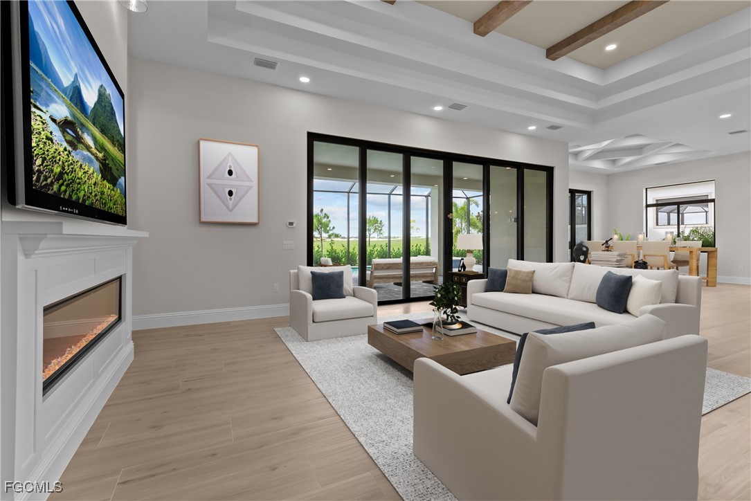 3383 Chestnut Grove Drive Alva, FL 33920 - Photo 5 of 33 a living room with furniture a fireplace and a large window