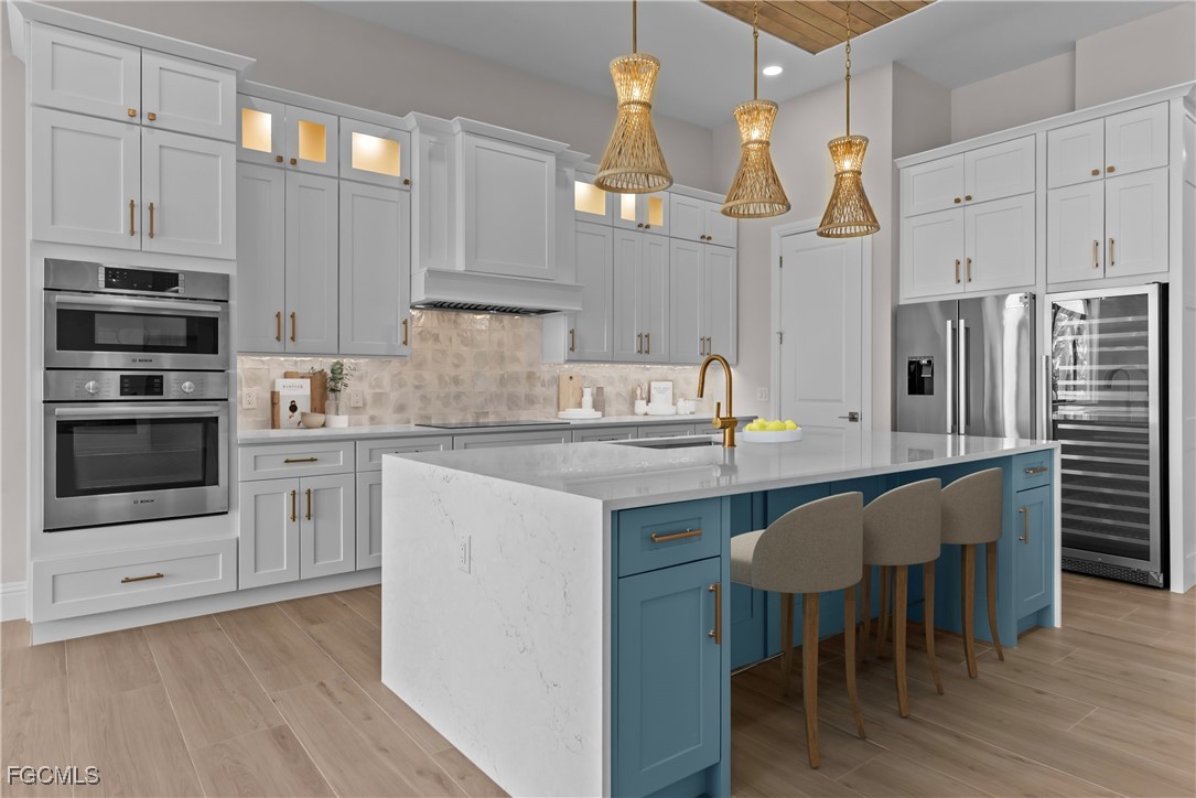 3383 Chestnut Grove Drive Alva, FL 33920 - Photo 6 of 33 a kitchen with stainless steel appliances a stove a sink island and a refrigerator