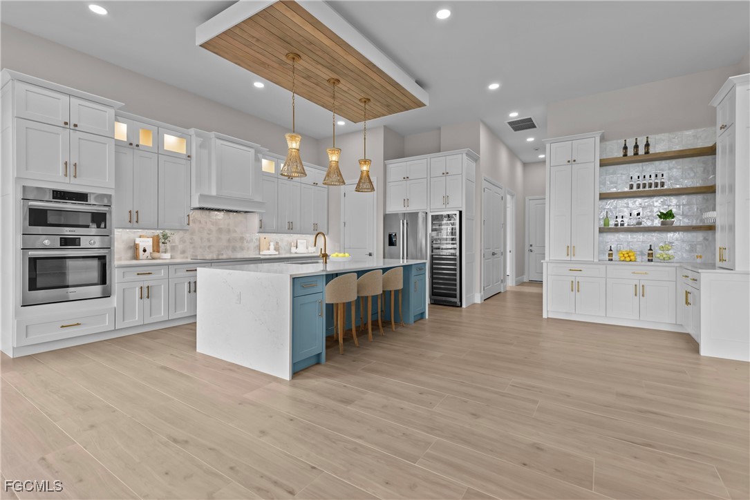 3383 Chestnut Grove Drive Alva, FL 33920 - Photo 8 of 33 a kitchen with stainless steel appliances a refrigerator sink and cabinets