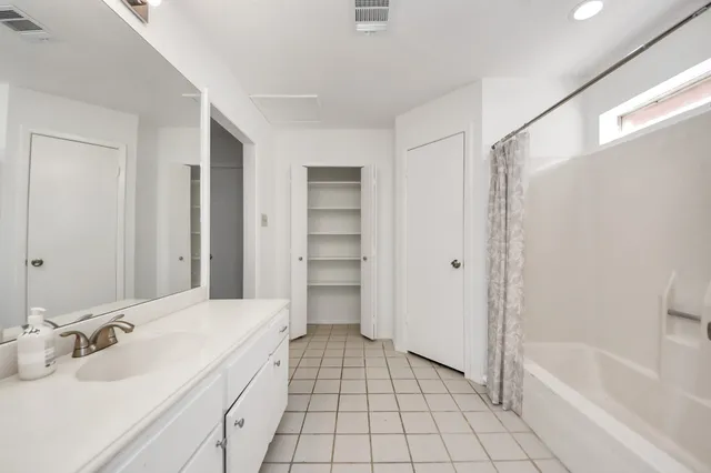 a spacious bathroom with a bathtub sink and toilet