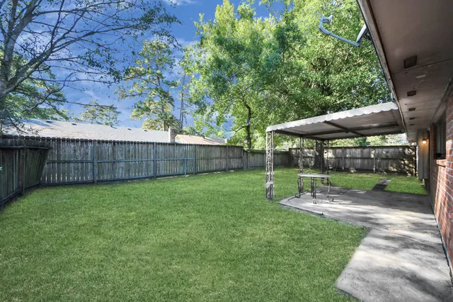 a view of a patio with a table and chairs under an umbrella