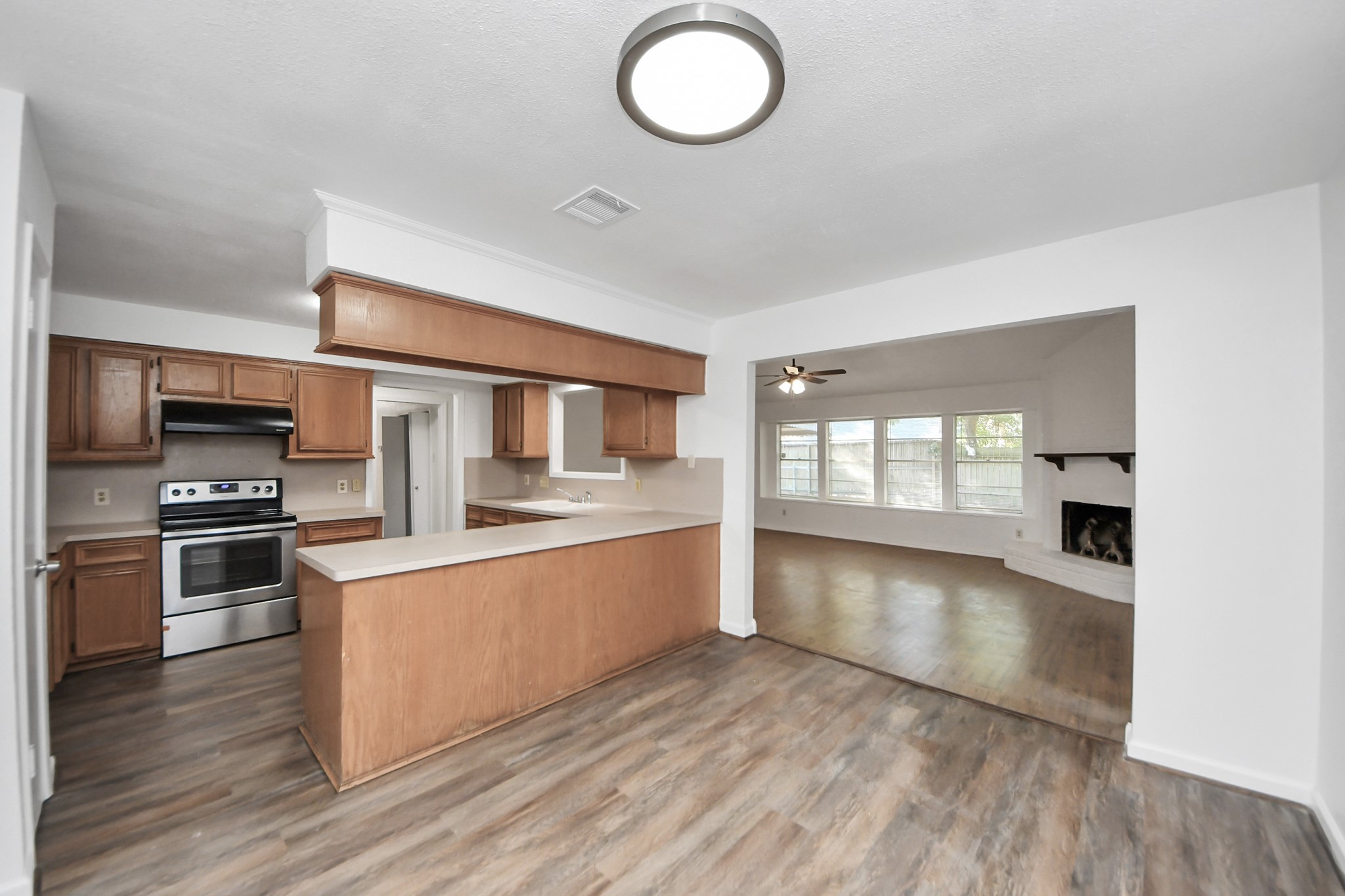 5306 Mossgrey Lane Spring, TX 77373 - Photo 6 of 19 a large kitchen with cabinets wooden floor and stainless steel appliances