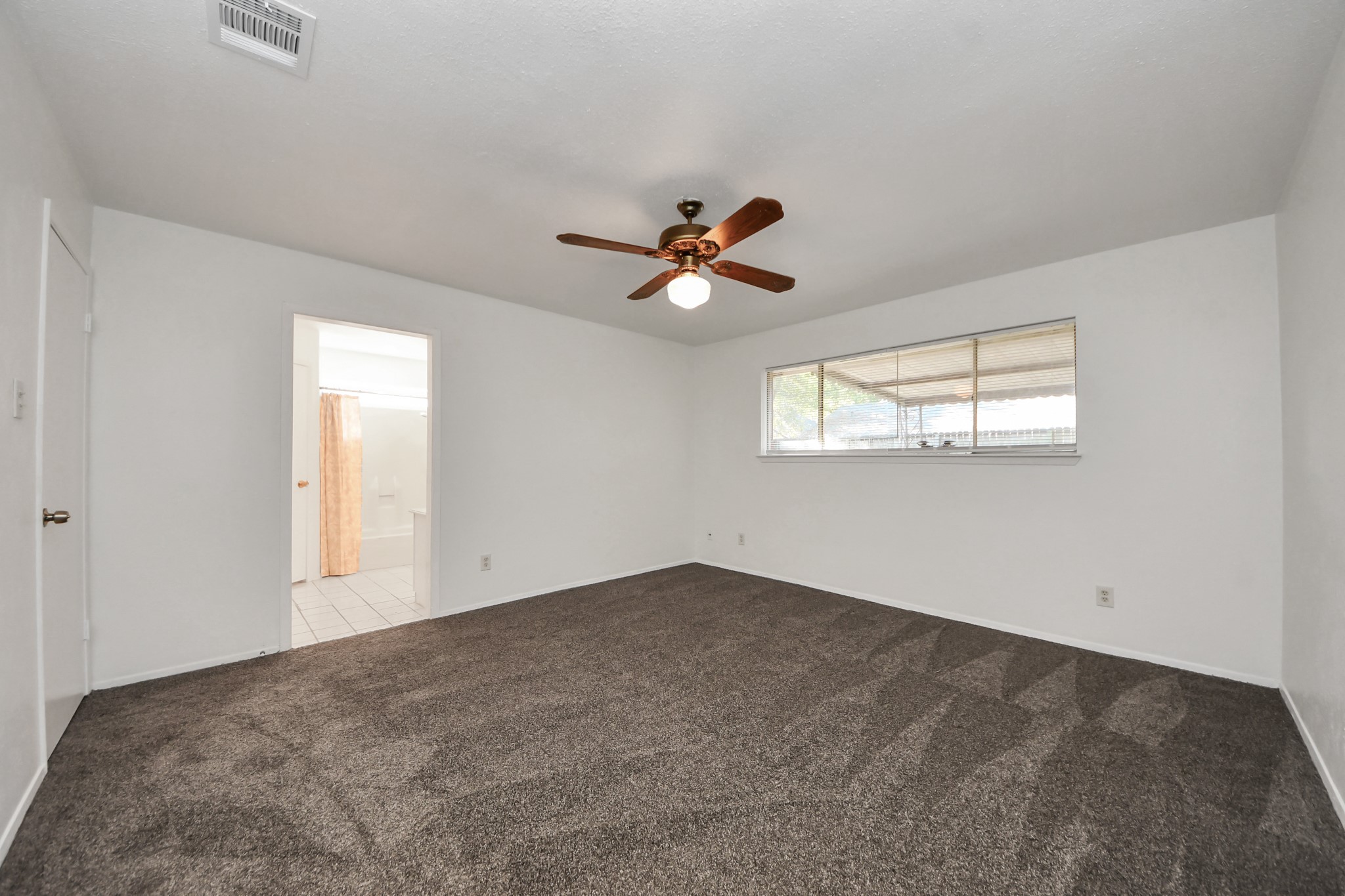 5306 Mossgrey Lane Spring, TX 77373 - Photo 9 of 19 an empty room with windows and ceiling fan