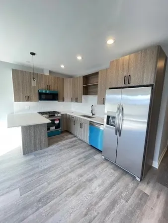 a kitchen with stainless steel appliances granite countertop a refrigerator sink and cabinets