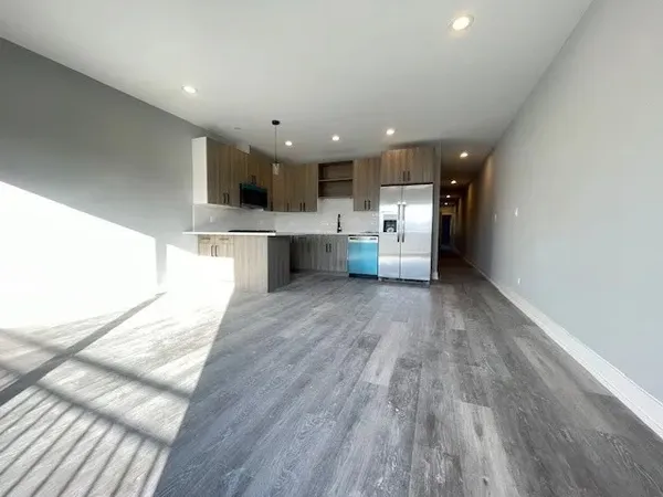 a view of kitchen with wooden floor and electronic appliances