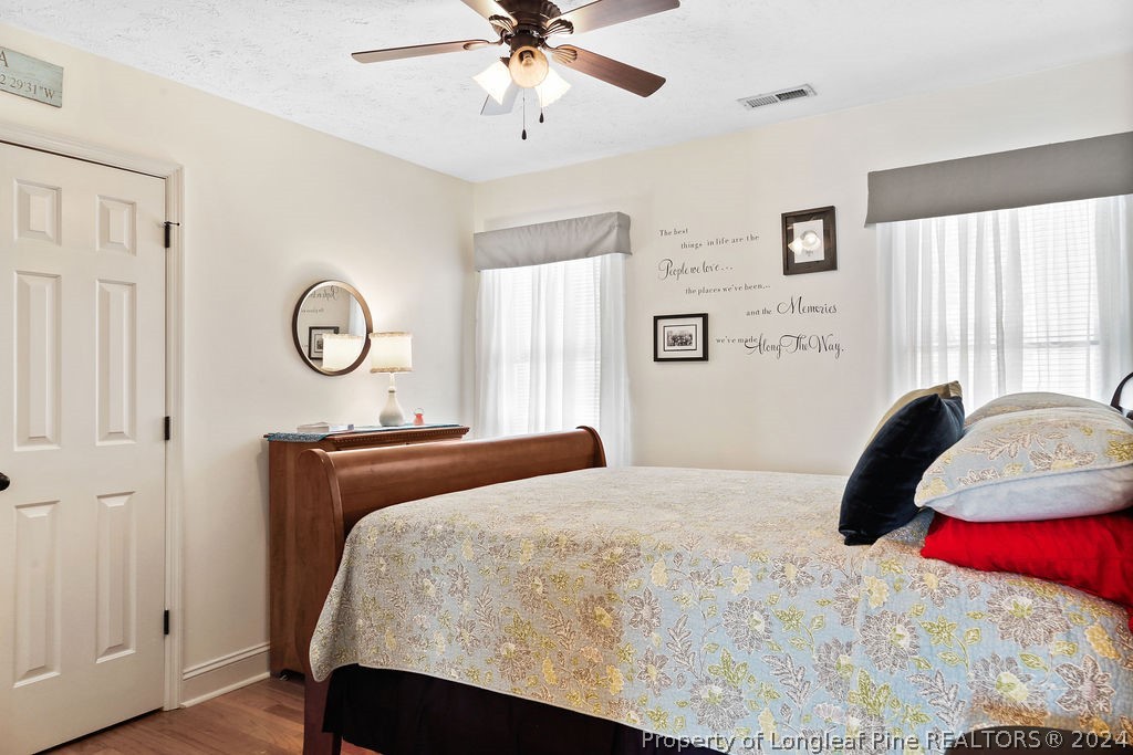 300 Shawcroft Road Fayetteville, NC 28311 - Photo 17 of 42 a bedroom with a bed and a chandelier