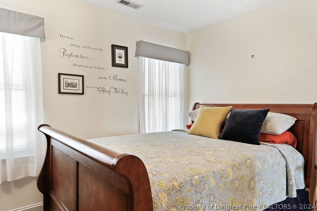300 Shawcroft Road Fayetteville, NC 28311 - Photo 18 of 42 a bedroom with a bed and wooden floor
