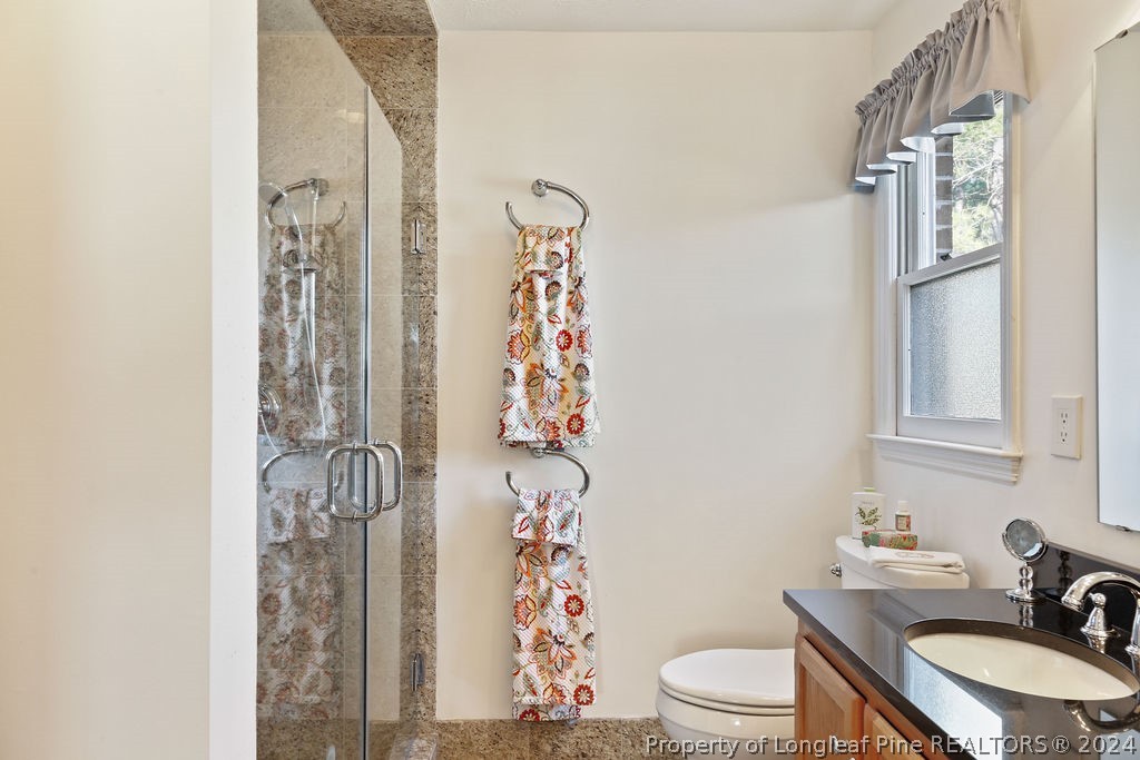 300 Shawcroft Road Fayetteville, NC 28311 - Photo 20 of 42 a bathroom with a sink a toilet and shower curtain
