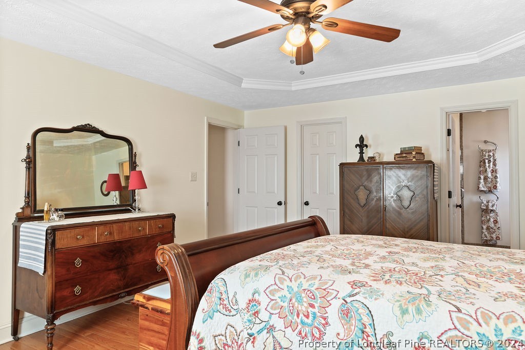 300 Shawcroft Road Fayetteville, NC 28311 - Photo 21 of 42 a bedroom with a bed and a chandelier
